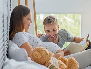 an image of an expecting a baby couple looking at bathroom renovations plan