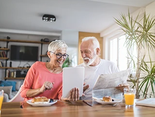 an image of an older couple looking at bathroom renovations plan